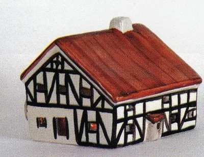 Ein detailliertes Modell einer Mühle im Fachwerkstil mit rotbraunen Dach.