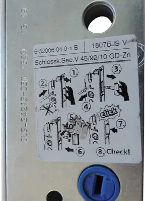 A close-up of a metal lock mechanism with an instructional sticker showing how to operate it.