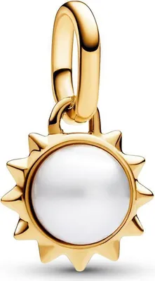 A close-up studio shot of a gold sun charm with a white pearl center.