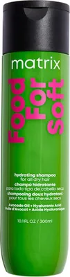A product shot of a green shampoo bottle with pink and white text.