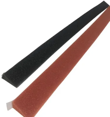 Two strips of foam, one black and one red, are laid diagonally on a white background.