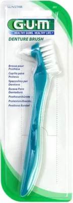 A packaged GUM Denture Brush.