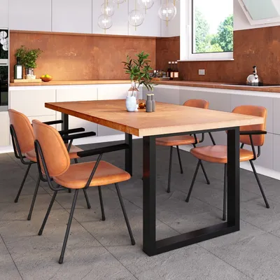 A dining table and chairs set in a modern kitchen.