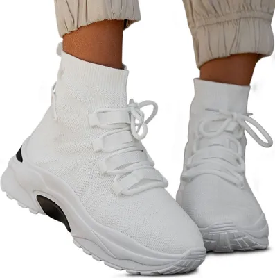A pair of white high-top sneakers worn by a person.