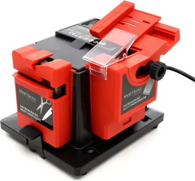 A close-up, angled view of a red and black electric knife and tool sharpener.