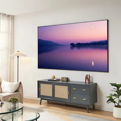 A living room scene with a large TV displaying a landscape image, a media console, a floor lamp, and a sofa.
