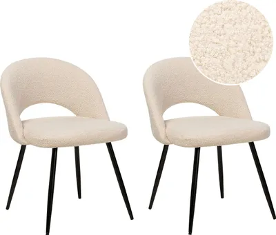Two beige bouclé chairs with black metal legs are shown against a white background.