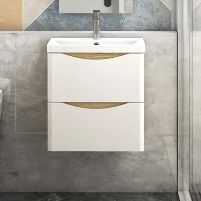 A modern bathroom vanity with a sink and two drawers, set against a textured wall.