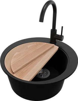 A black kitchen sink with a faucet and wooden cutting boards on top.