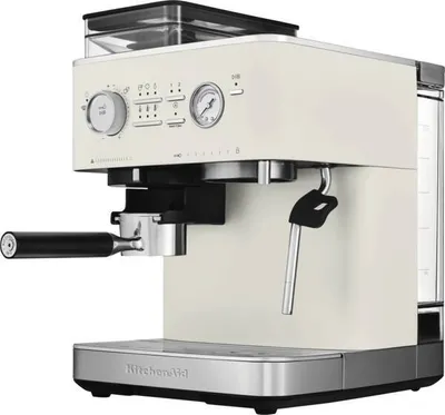 A cream-colored KitchenAid espresso machine with a black portafilter and steam wand, shown from a side-front angle on a white background.