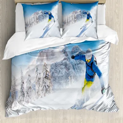 A duvet cover and pillowcases with a winter skiing theme, featuring a skier in action against a snowy mountain backdrop.