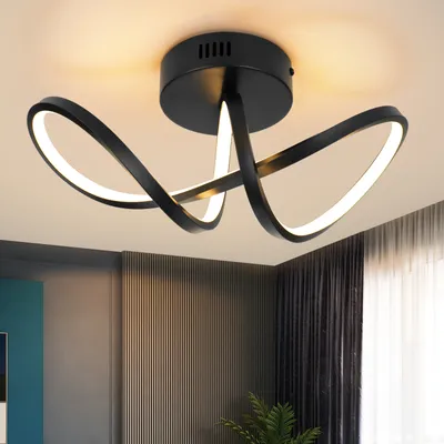 A modern black ceiling light with intertwined loops and integrated LED lighting, mounted on a white ceiling.