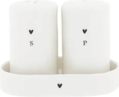 A set of white salt and pepper shakers with a tray.