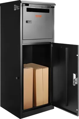 A black parcel mailbox with its lower door open, revealing two cardboard boxes inside. The upper section has a slot and a combination lock.