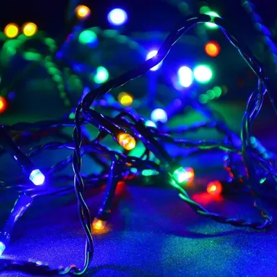 A close-up, macro shot of a tangled string of colorful LED lights.