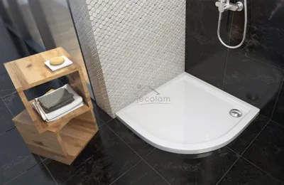 A modern bathroom corner with a white shower tray, tiled wall, and wooden storage unit.