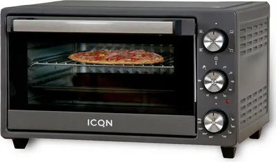 A dark gray countertop oven with a pizza inside is shown on a light gray background.