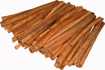 A pile of cinnamon sticks on a white background.
