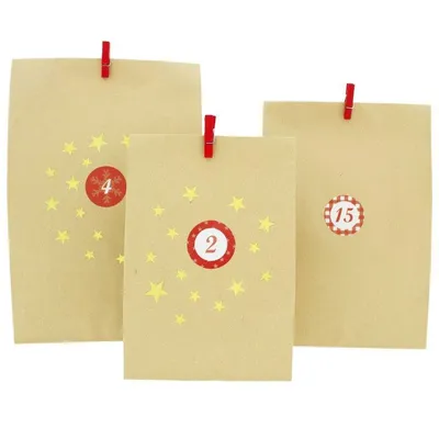 Three brown paper bags decorated with yellow stars and numbered red circles, clipped to an unseen surface with red clips.
