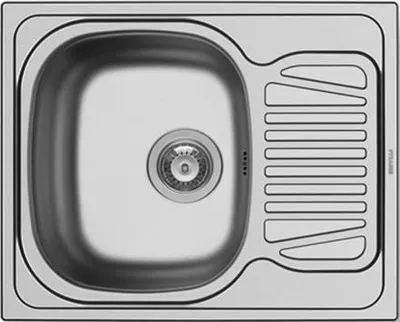 A top-down view of a stainless steel kitchen sink with a drainboard.