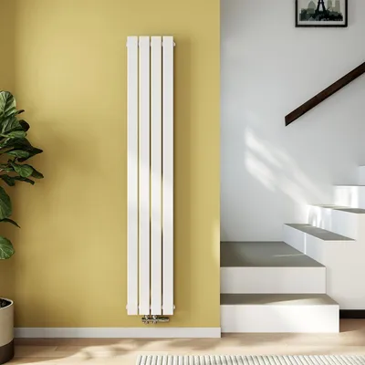 A modern interior scene with a white vertical radiator against a yellow wall, next to a staircase.