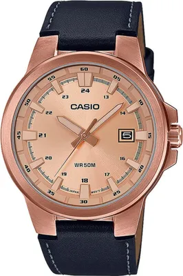 A close-up studio shot of a Casio watch with a rose gold case and a black leather strap.