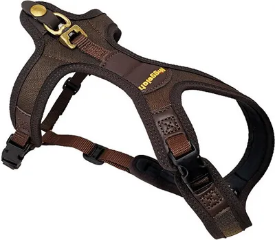 A brown dog harness is shown against a white background.