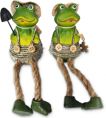 Two decorative frog figures with hanging legs, dressed in overalls and hats, against a white background.