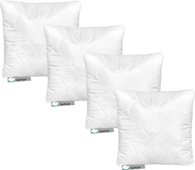 Four white pillows are arranged in a staggered formation against a white background.