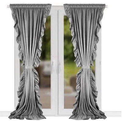 Two gray velvet curtains with ruffles are shown hanging in front of a window.