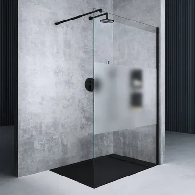 A modern shower enclosure with a black frame and a frosted glass panel, set against a textured gray wall.