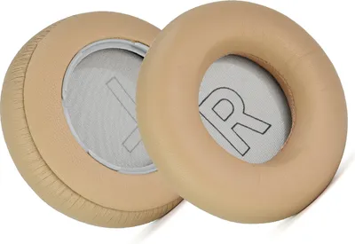 Two beige ear pads for headphones are shown against a white background.