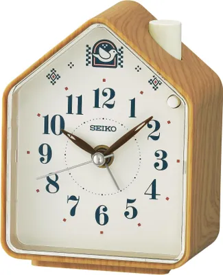 A close-up studio shot of a SEIKO alarm clock with a wood-grain finish.