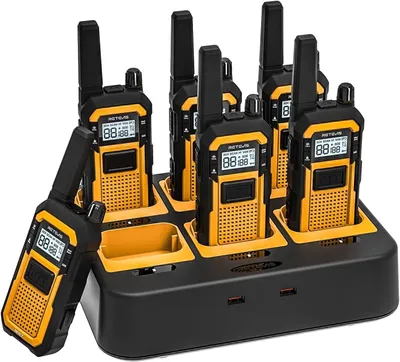 A set of six walkie-talkies in a charging dock.