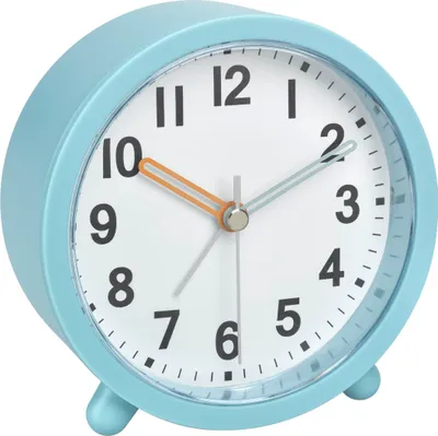 A close-up studio shot of a turquoise analog alarm clock.