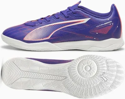 A pair of Puma indoor soccer shoes shown from the side and from the sole.