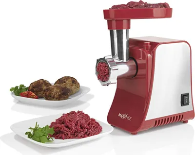 A red and silver meat grinder is shown with ground meat and meatballs on plates in front of it.