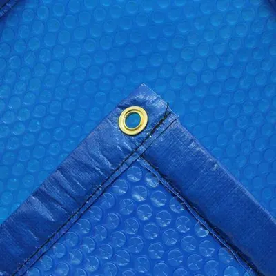 Close-up of a blue solar pool cover corner with a grommet.