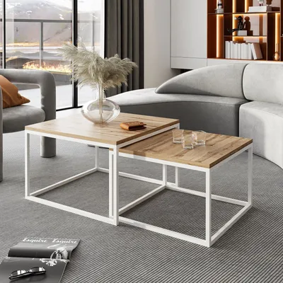 A modern living room with a sectional sofa, armchair, and nesting coffee tables.