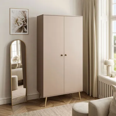 A bedroom scene featuring a wardrobe, mirror, and armchair.