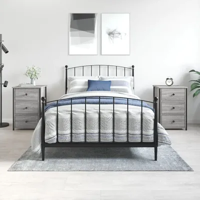 A bedroom scene with a bed and two nightstands.