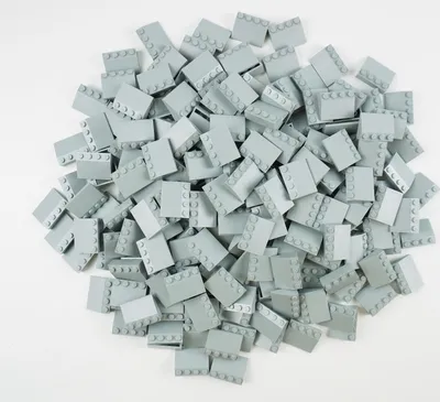 A pile of light gray LEGO bricks on a white background.