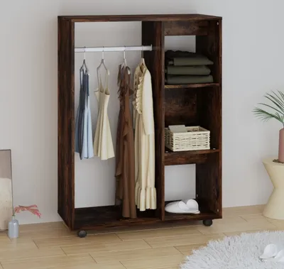 A dark wood-effect wardrobe with clothes hanging and items on shelves.