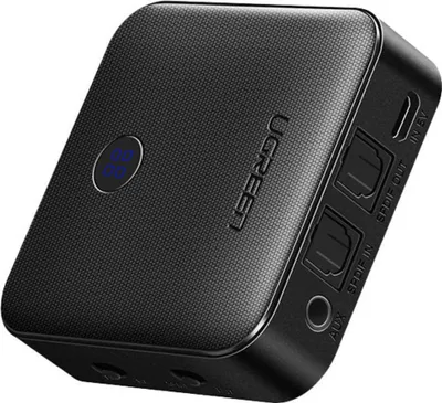 A black Ugreen Bluetooth receiver and transmitter is shown from a diagonal angle against a black background.