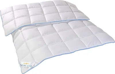 A white quilted comforter with blue trim is shown against a white background.