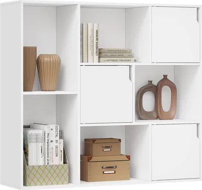 A white bookshelf with various items on its shelves.
