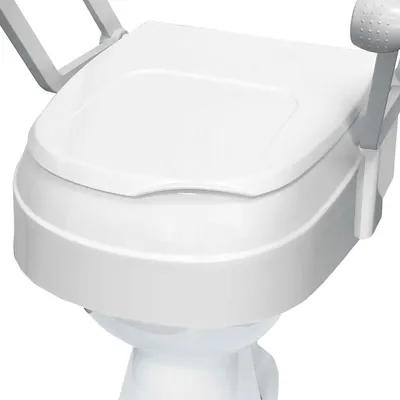 A close-up, angled view of a white toilet seat riser with gray armrests.