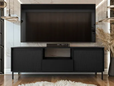 A modern living room featuring a black media console with a TV mounted above it.