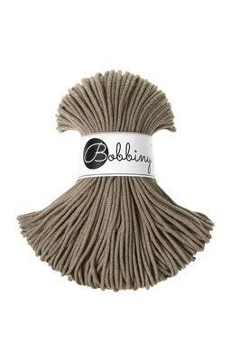 A spool of brown macrame cord is shown against a white background. A label with the brand name 'Bobbiny' is wrapped around the spool.