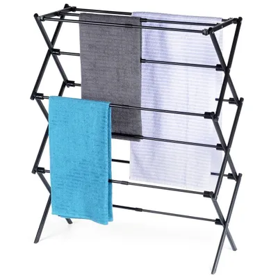 A black metal drying rack with three towels hanging on it.